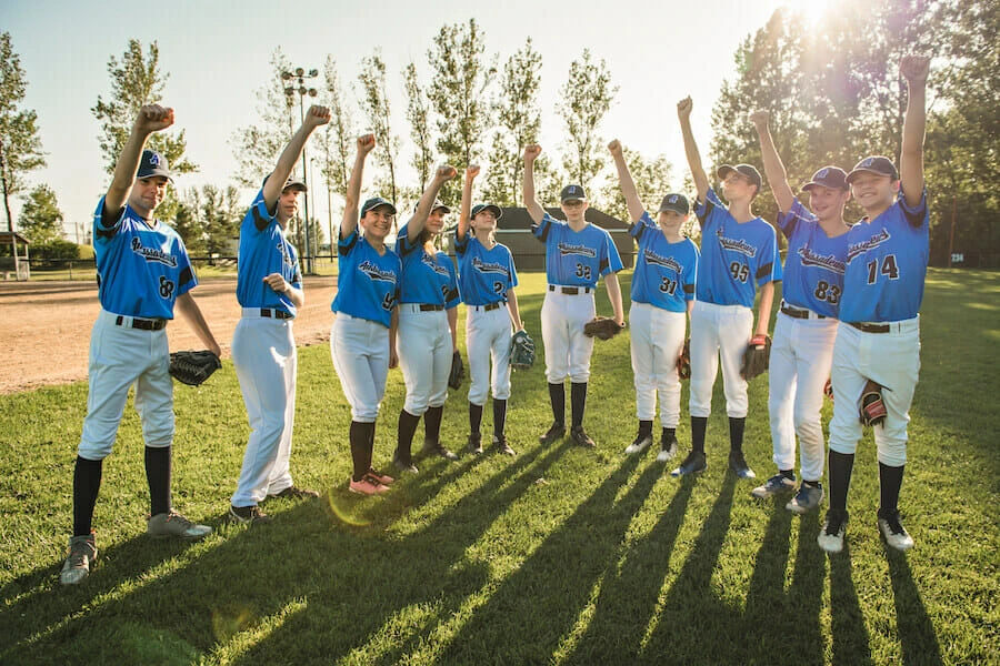 team of baseball players using their team caps